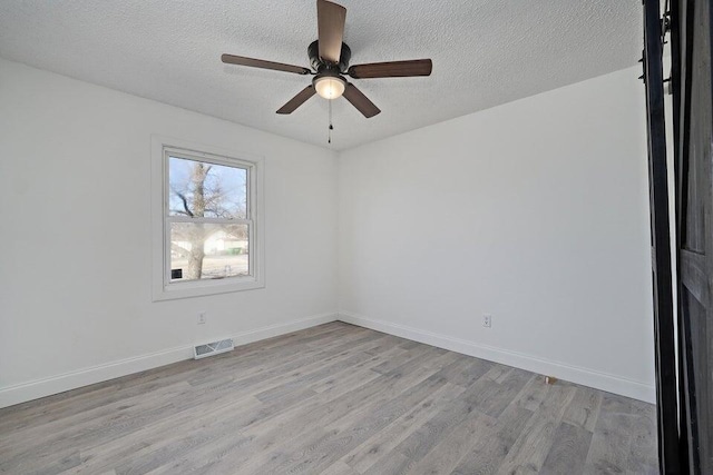 502 S Walnut St, Walnut Grove, MO 65770 - unfurnished room featuring light wood-style floors, a textured ceiling, and ceiling fan