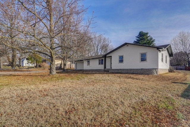 502 S Walnut St, Walnut Grove, MO 65770 - rear view of house with a garage and a lawn