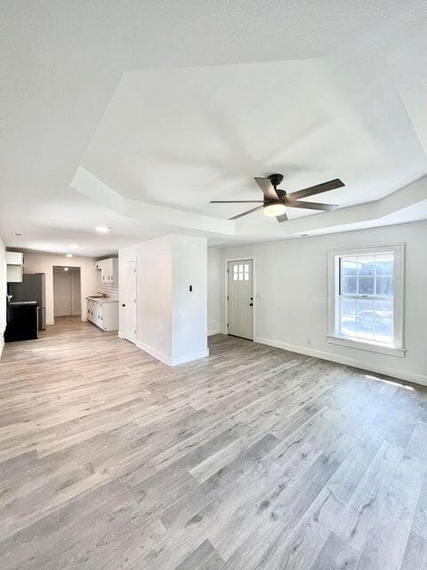 900 N Eagle Ave, Springfield, MO 65802 - unfurnished living room with ceiling fan and light wood-style floors
