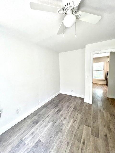 900 N Eagle Ave, Springfield, MO 65802 - spare room with wood finished floors and ceiling fan