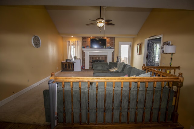 301 N Gregg Rd, Nixa, MO 65714 - living area with vaulted ceiling, a ceiling fan, a fireplace, and wood finished floors