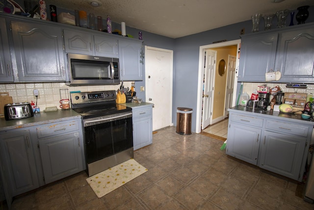 301 N Gregg Rd, Nixa, MO 65714 - kitchen with stainless steel appliances, decorative backsplash, and gray cabinets