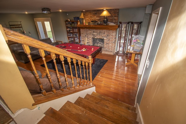 301 N Gregg Rd, Nixa, MO 65714 - staircase with a brick fireplace and wood finished floors