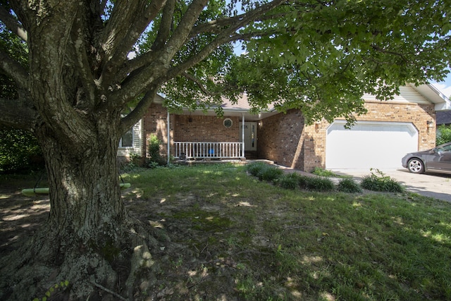 301 N Gregg Rd, Nixa, MO 65714 - obstructed view of property featuring brick siding, an attached garage, a porch, driveway, and a front lawn