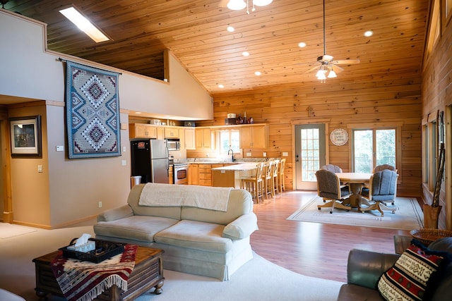 20816 Valley View Trl, Wheatland, MO 65779 - living area featuring high vaulted ceiling, recessed lighting, wooden ceiling, wooden walls, and light wood-style flooring