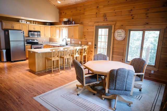 20816 Valley View Trl, Wheatland, MO 65779 - dining space featuring healthy amount of natural light, light wood-style flooring, wooden walls, wood ceiling, and high vaulted ceiling