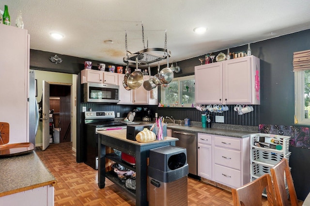 528 N Locust St, Marshfield, MO 65706 - kitchen with stainless steel appliances, plenty of natural light, white cabinets, and recessed lighting
