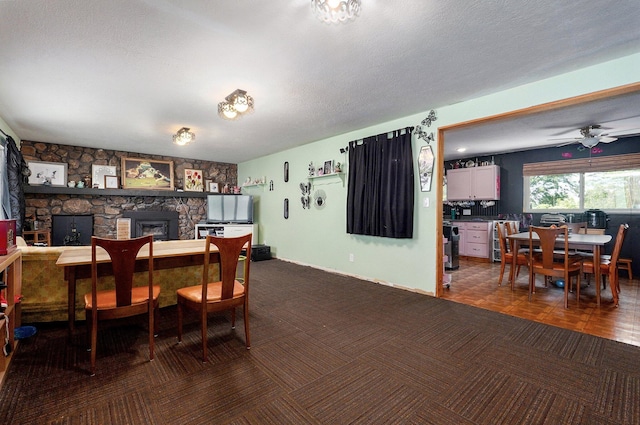 528 N Locust St, Marshfield, MO 65706 - dining space featuring a fireplace, dark carpet, a textured ceiling, wine cooler, and ceiling fan