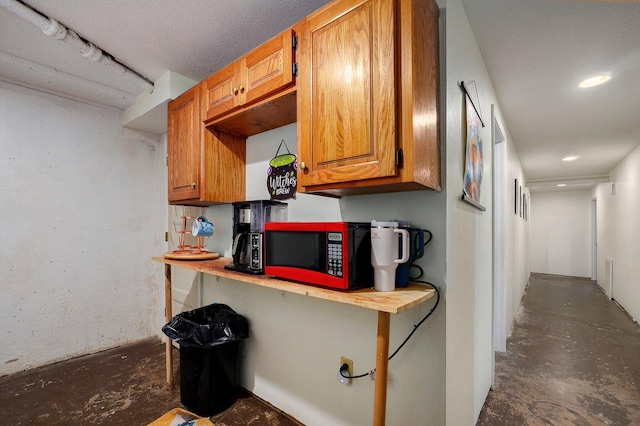 528 N Locust St, Marshfield, MO 65706 - kitchen with unfinished concrete flooring, brown cabinets, and recessed lighting
