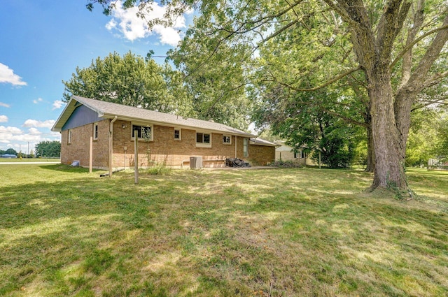 528 N Locust St, Marshfield, MO 65706 - rear view of house featuring brick siding and a lawn