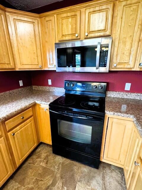 1359 W Stone House Rd, Nixa, MO 65714 - kitchen with black range with electric cooktop and stainless steel microwave