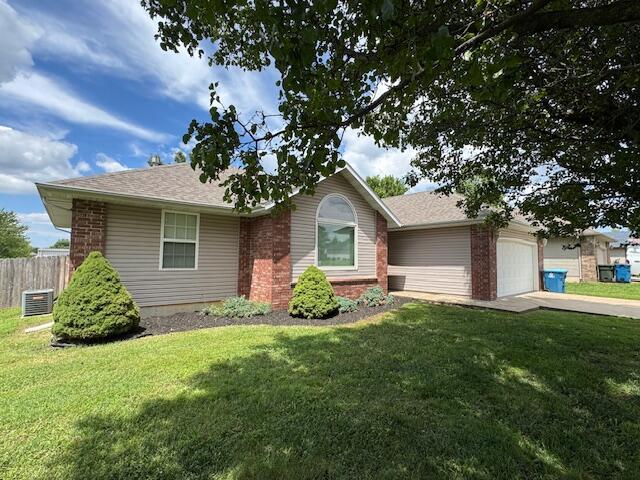 1359 W Stone House Rd, Nixa, MO 65714 - single story home with an attached garage, brick siding, concrete driveway, and roof with shingles