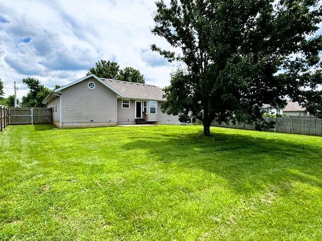 1359 W Stone House Rd, Nixa, MO 65714 - back of property featuring a fenced backyard