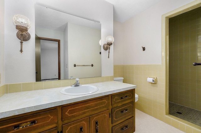3520 E Carol Dr, Springfield, MO 65809 - bathroom with vanity, a tile shower, tile walls, wainscoting, and tile patterned floors