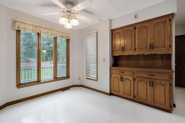 3520 E Carol Dr, Springfield, MO 65809 - unfurnished dining area featuring baseboards and a ceiling fan