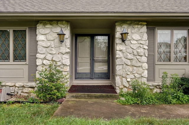 3520 E Carol Dr, Springfield, MO 65809 - entrance to property with a shingled roof and stone siding