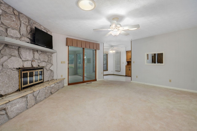 3520 E Carol Dr, Springfield, MO 65809 - unfurnished living room with ceiling fan, a fireplace, and light colored carpet