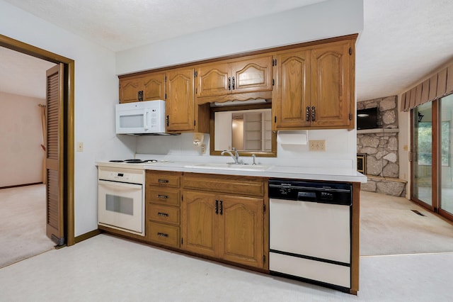 3520 E Carol Dr, Springfield, MO 65809 - kitchen with white appliances, light colored carpet, light countertops, and brown cabinets