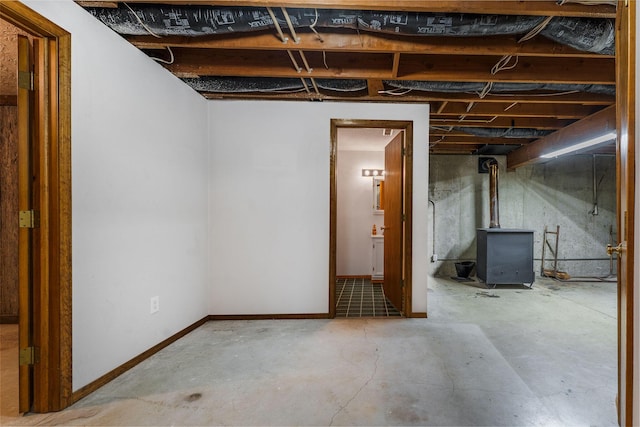 2131 Redoak Rd, Fordland, MO 65652 - unfinished below grade area featuring baseboards and a wood stove