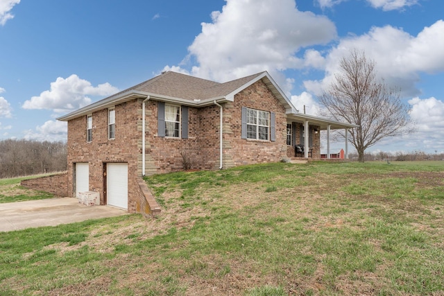2131 Redoak Rd, Fordland, MO 65652 - view of side of home with concrete driveway, a garage, covered porch, brick siding, and a lawn