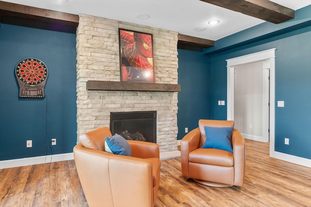 6421 S Valley Brook Ct, Springfield, MO 65810 - living room with wood finished floors, beam ceiling, and a large fireplace