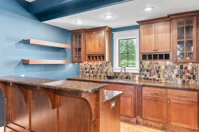 6421 S Valley Brook Ct, Springfield, MO 65810 - kitchen featuring open shelves, tasteful backsplash, dark stone counters, glass insert cabinets, and recessed lighting
