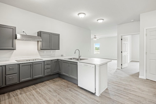 kitchen featuring dishwasher, range hood, gray cabinets, black electric stovetop, and a peninsula