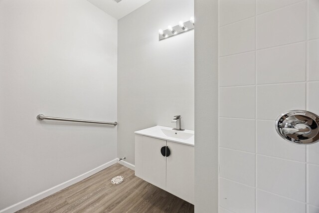 bathroom with wood finished floors and vanity