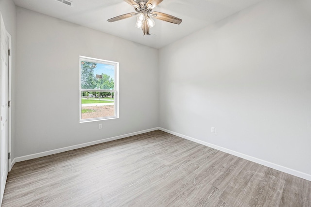 spare room featuring light wood-style floors and a ceiling fan
