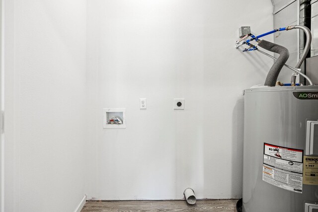 washroom featuring electric water heater, hookup for an electric dryer, wood finished floors, and washer hookup