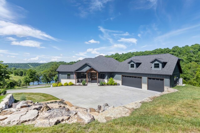 564 Marcasite Way, Branson West, MO 65737 - modern inspired farmhouse with asphalt driveway, a shingled roof, covered porch, board and batten siding, and a front lawn