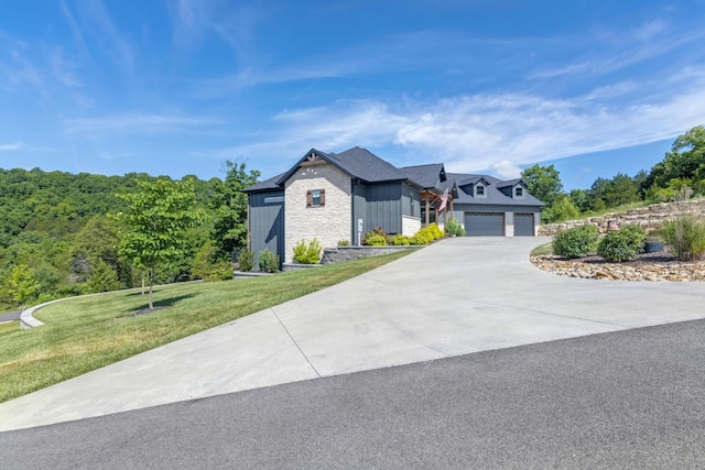 564 Marcasite Way, Branson West, MO 65737 - view of front of home with stone siding, driveway, a front yard, an attached garage, and board and batten siding
