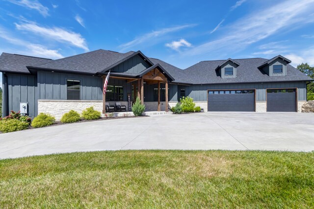 564 Marcasite Way, Branson West, MO 65737 - modern farmhouse style home featuring board and batten siding, an attached garage, stone siding, and concrete driveway