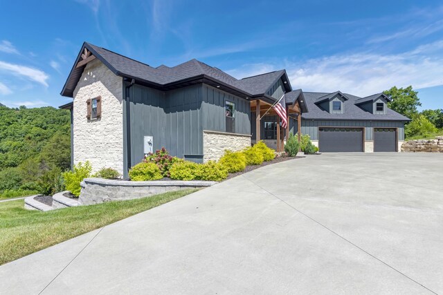 564 Marcasite Way, Branson West, MO 65737 - view of front of home with stone siding, board and batten siding, concrete driveway, an attached garage, and a shingled roof