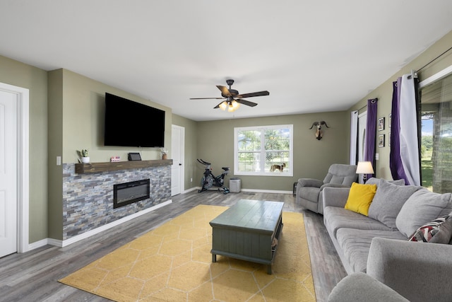 2080 State Route 14, West Plains, MO 65775 - living area featuring wood finished floors, a fireplace, and ceiling fan