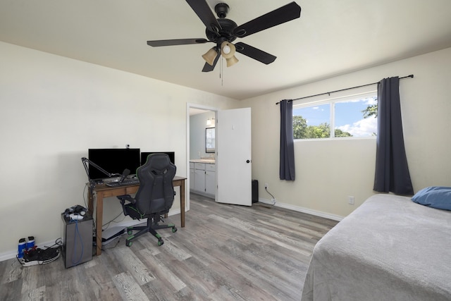 2080 State Route 14, West Plains, MO 65775 - bedroom with light wood finished floors, a desk, connected bathroom, and a ceiling fan