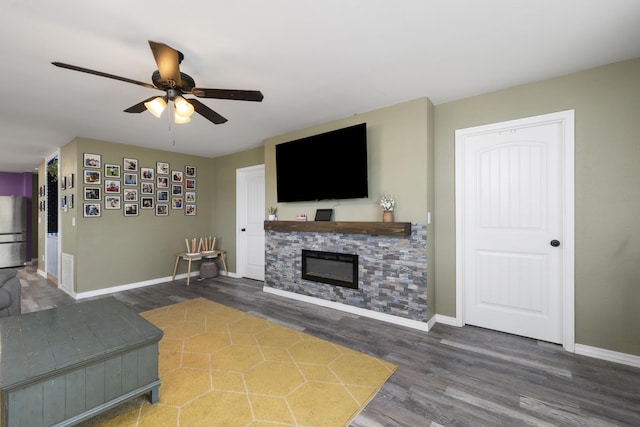 2080 State Route 14, West Plains, MO 65775 - living area featuring wood finished floors, a ceiling fan, and a fireplace