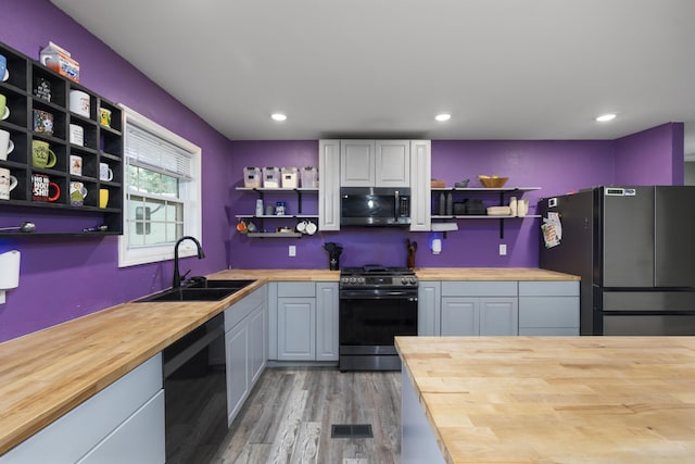 2080 State Route 14, West Plains, MO 65775 - kitchen featuring wooden counters, open shelves, appliances with stainless steel finishes, light wood finished floors, and recessed lighting