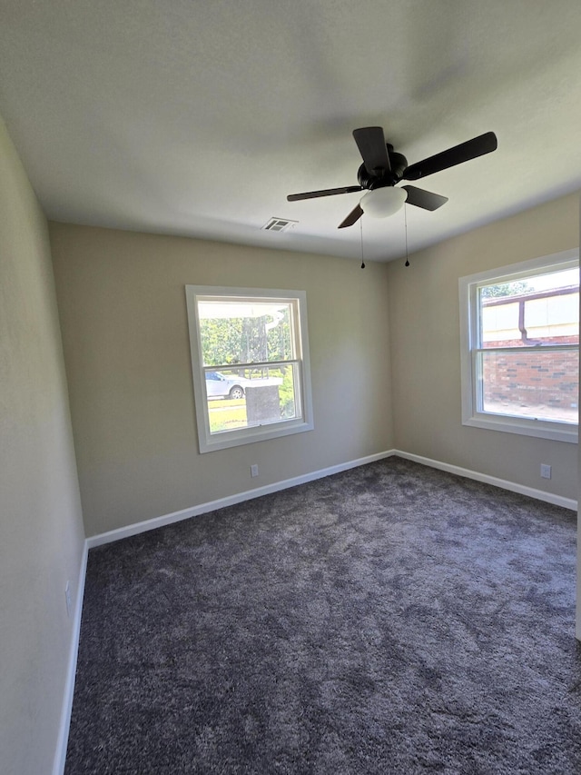 1008 3rd St, Monett, MO 65708 - spare room with dark colored carpet and ceiling fan