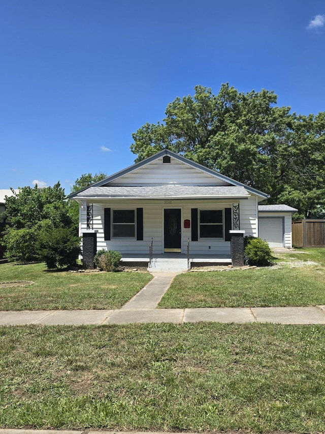 1008 3rd St, Monett, MO 65708 - bungalow-style home with a porch and a garage