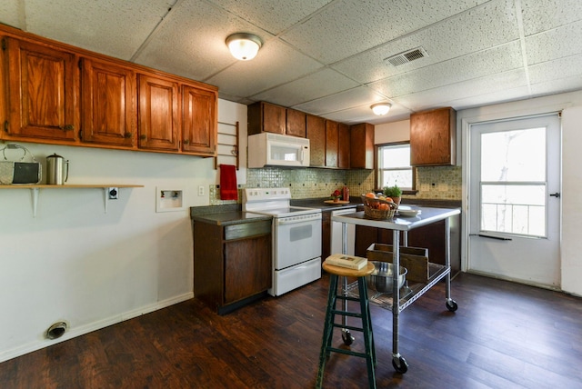 9755 State Highway 13, Kimberling City, MO 65686 - kitchen featuring white appliances, decorative backsplash, dark wood finished floors, a drop ceiling, and brown cabinets