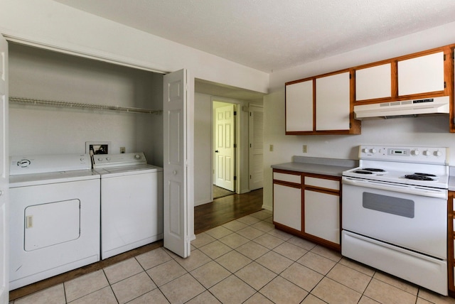9755 State Highway 13, Kimberling City, MO 65686 - kitchen featuring white electric range oven, under cabinet range hood, independent washer and dryer, and light countertops