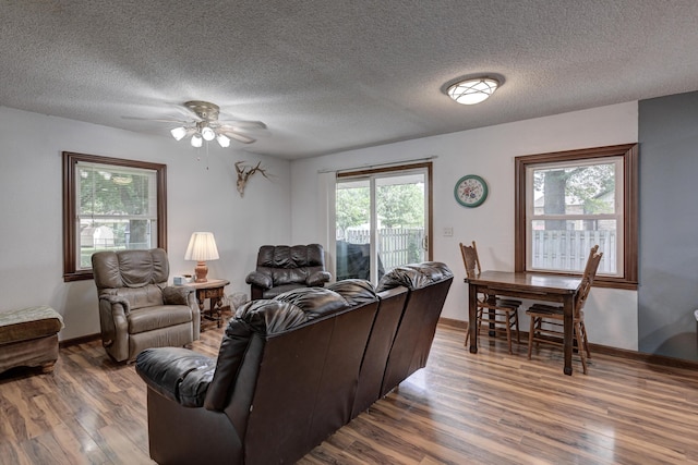 2148 Carrie St, Carthage, MO 64836 - living area with wood finished floors, ceiling fan, and a textured ceiling