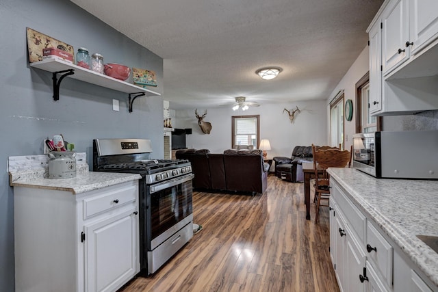 2148 Carrie St, Carthage, MO 64836 - kitchen featuring stainless steel appliances, white cabinetry, ceiling fan, wood finished floors, and a textured ceiling