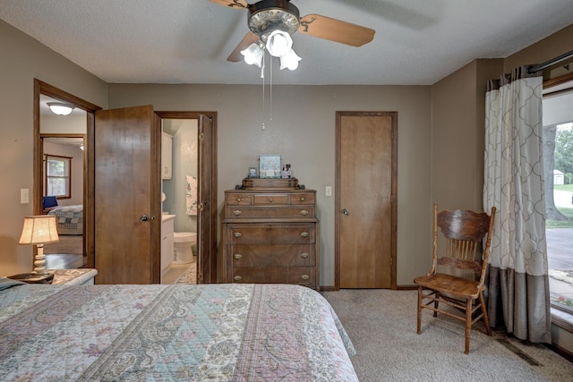 2148 Carrie St, Carthage, MO 64836 - bedroom featuring light colored carpet, connected bathroom, and a ceiling fan