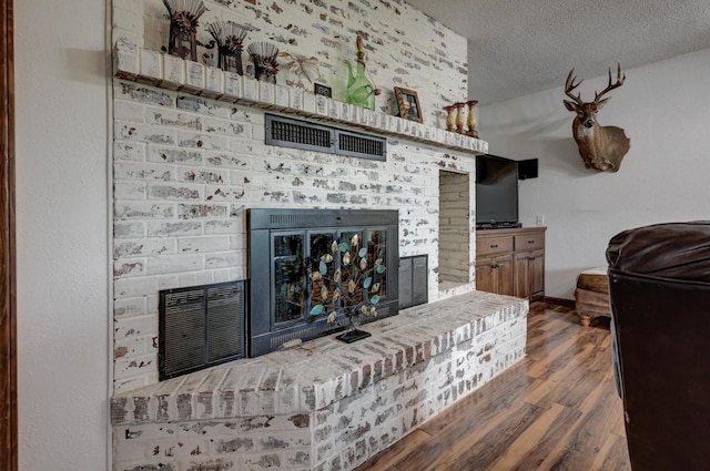 2148 Carrie St, Carthage, MO 64836 - living area featuring a fireplace, wood finished floors, and a textured ceiling