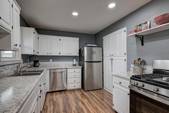 2148 Carrie St, Carthage, MO 64836 - kitchen with stainless steel appliances, white cabinetry, wood finished floors, open shelves, and recessed lighting