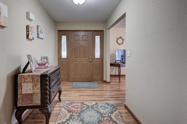 2148 Carrie St, Carthage, MO 64836 - entryway with light wood-style flooring, a textured ceiling, and a textured wall