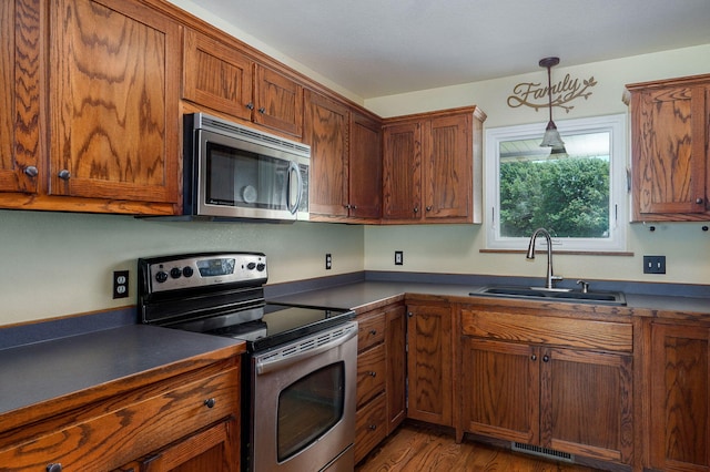 14521 Lawrence Unit 2145, Mount Vernon, MO 65712 - kitchen featuring appliances with stainless steel finishes, dark countertops, and brown cabinets