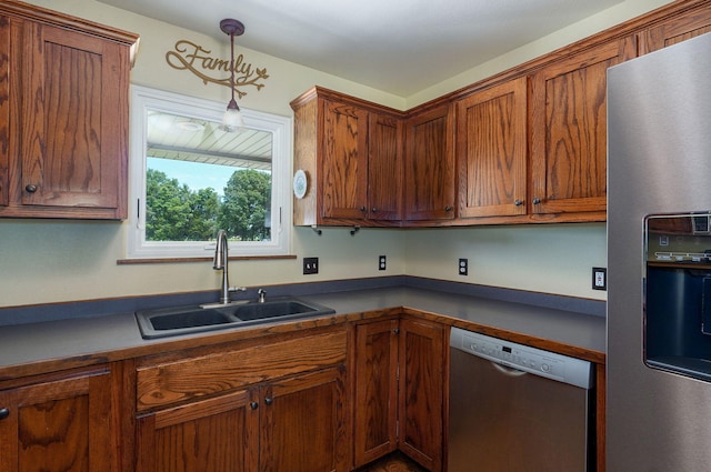 14521 Lawrence Unit 2145, Mount Vernon, MO 65712 - kitchen with appliances with stainless steel finishes, pendant lighting, dark countertops, and brown cabinetry